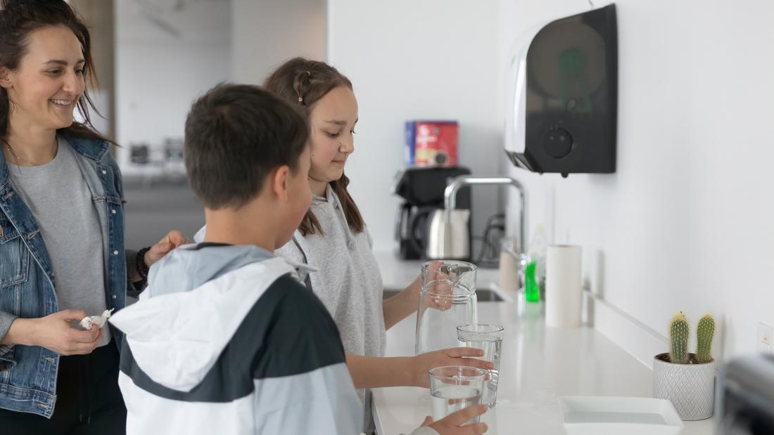 Mom helping her kids in the kitchen 