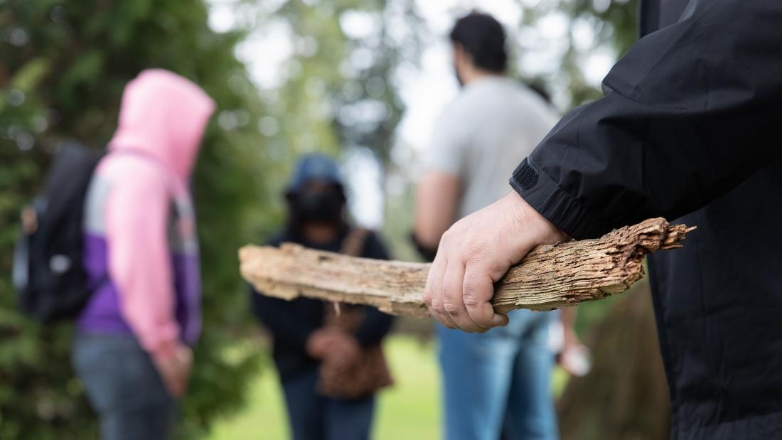 Man with stick about to strike other youth 