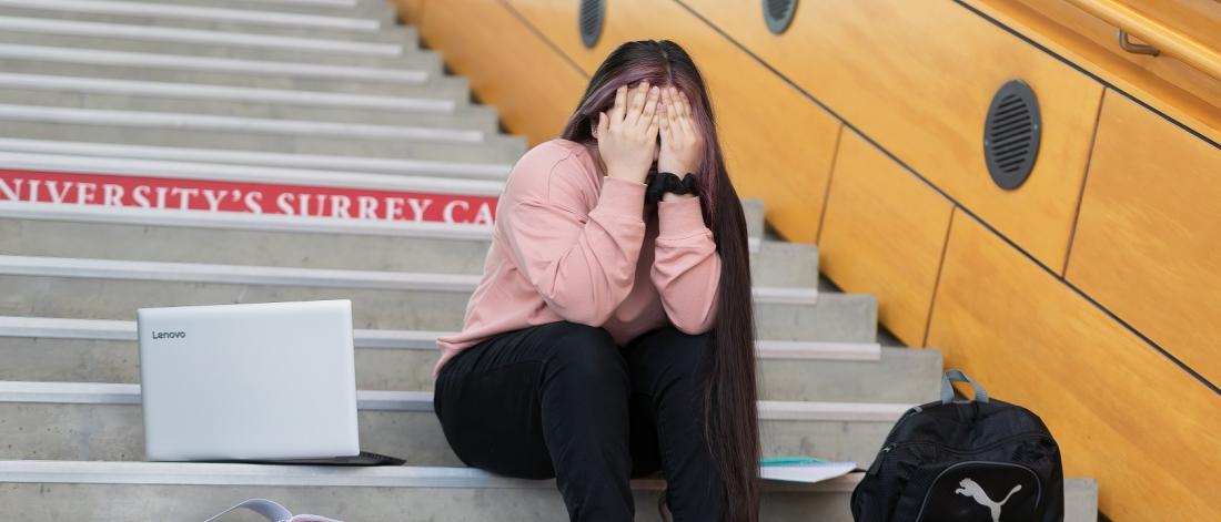 Young female holding her head due to stress 