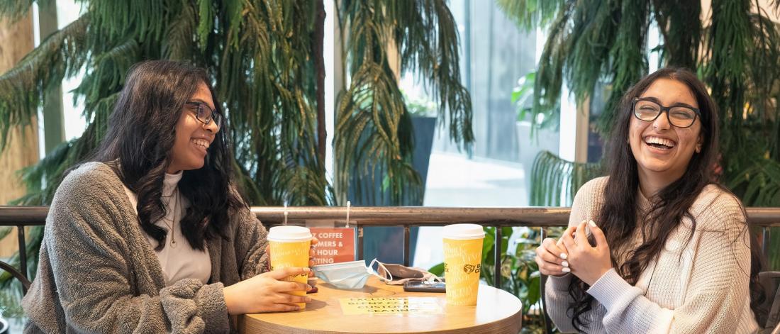 Two girls having coffee together