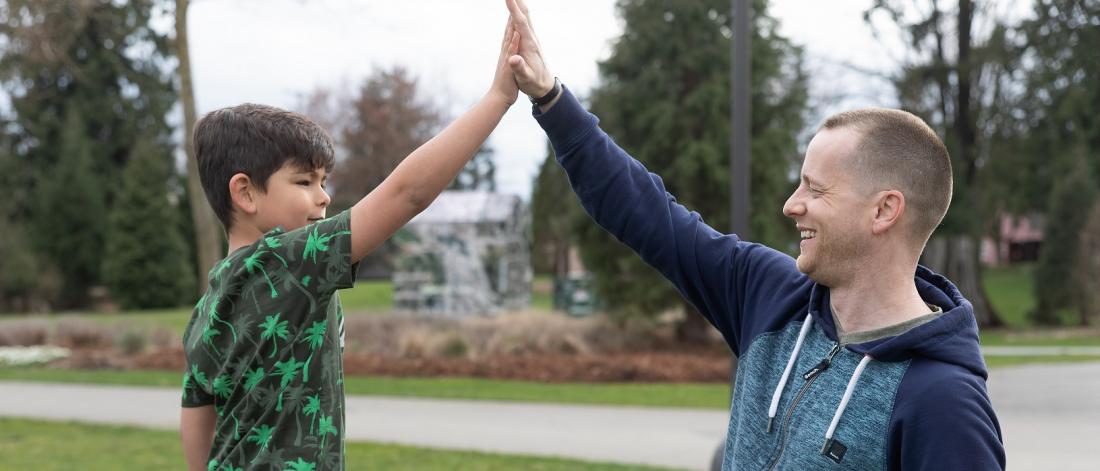 Dad and child high fiving 