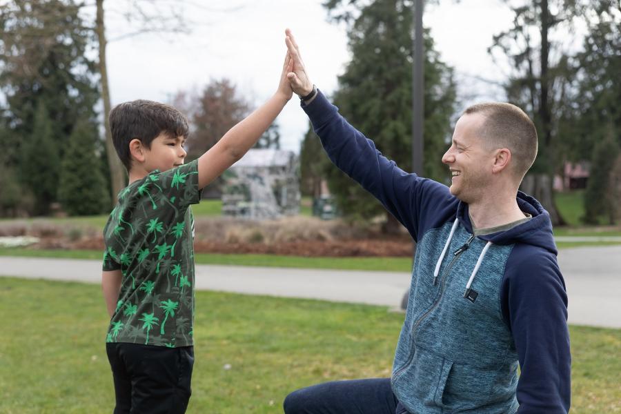 Father and son high fiving 